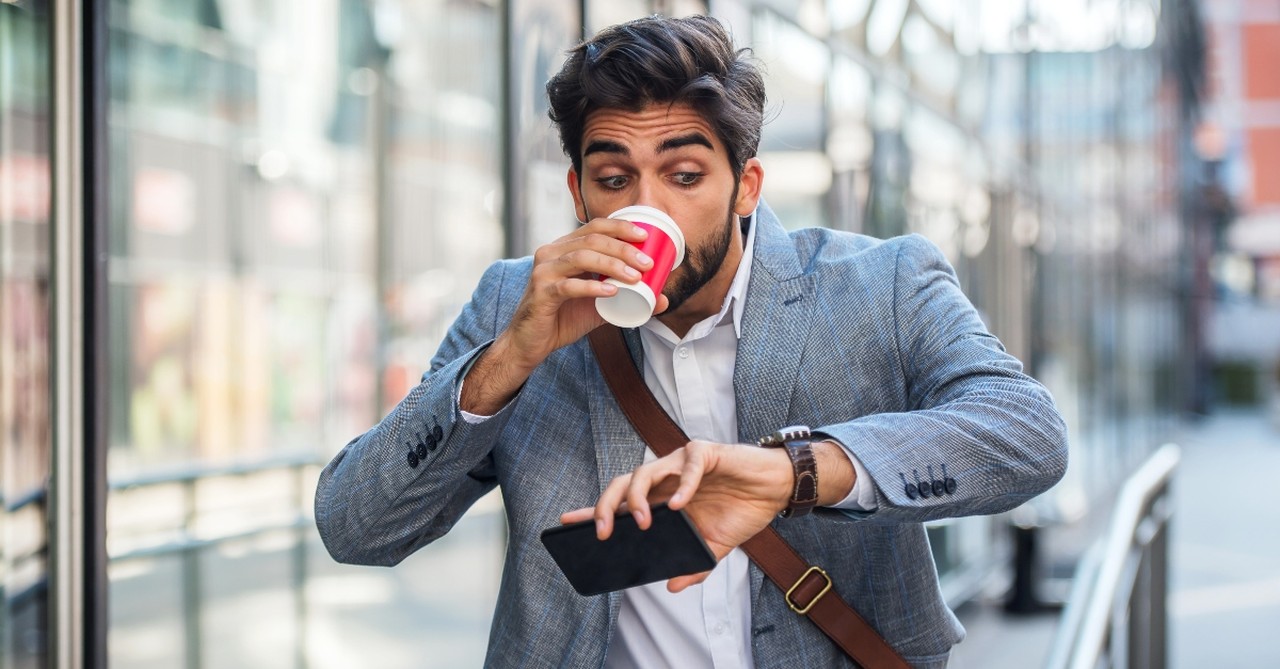 Man checking his watch in alarm