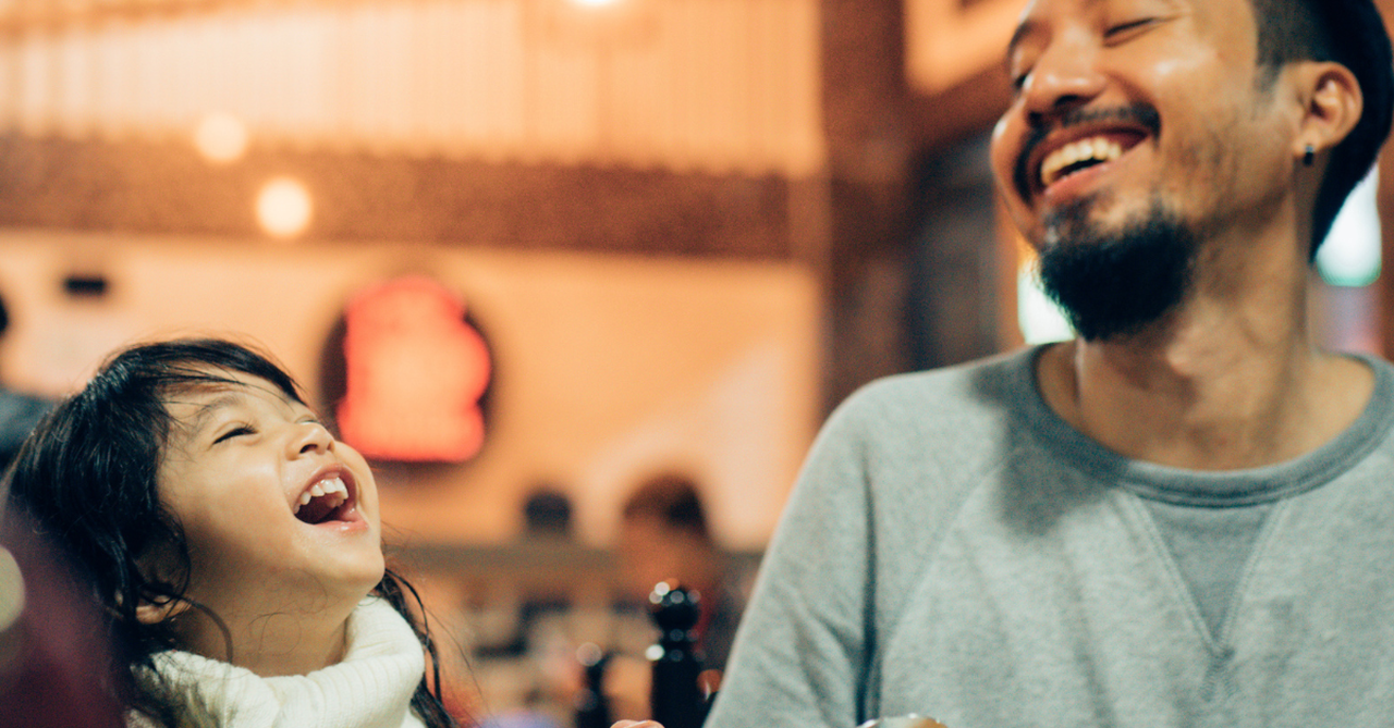 Dad and daughter at a restaurant.