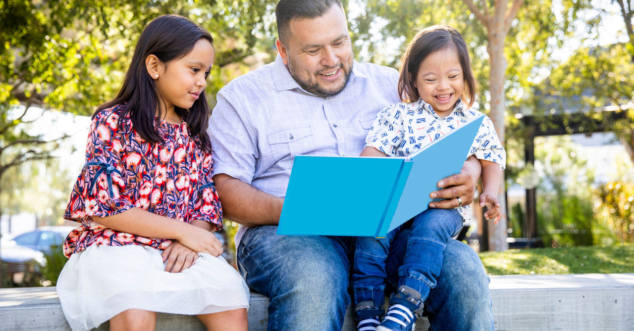 Dad reading to his daughters.