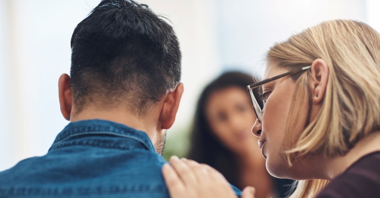 woman patting man's shoulder, how to deal with grief