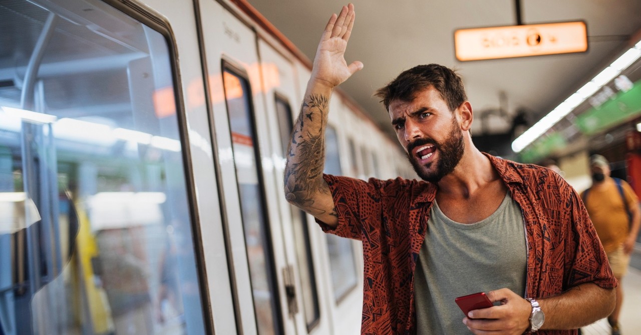 Man angry as the subway goes passed