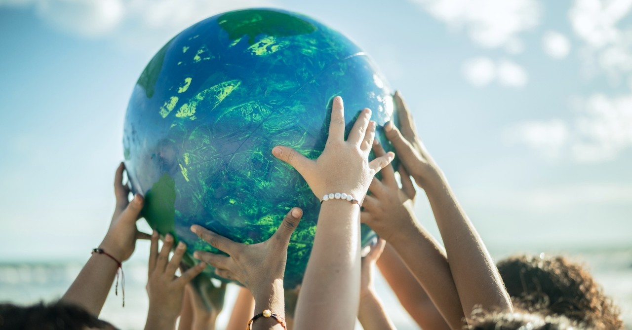 Kids holding a globe