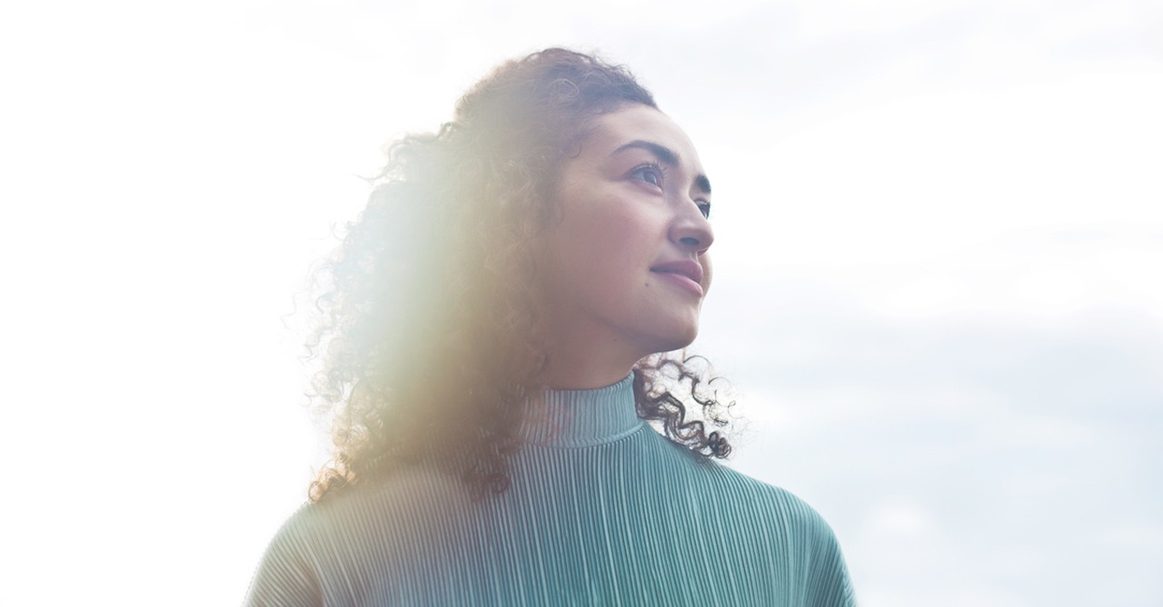 woman looking up at sky thinking