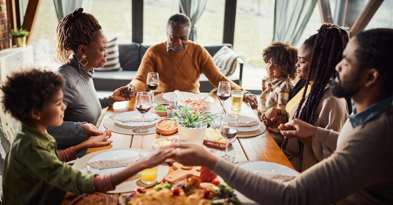 Family praying at dinner