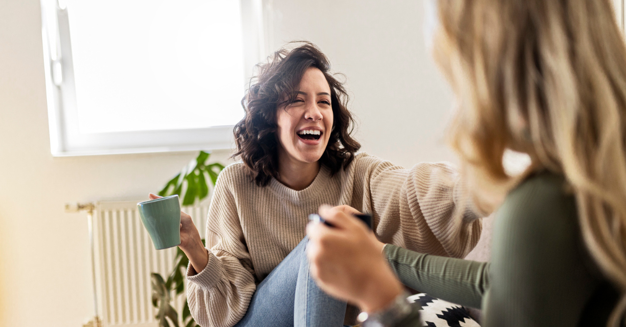 Two friends having coffee together, laughing; seven pocket prayers to pray for your friends.