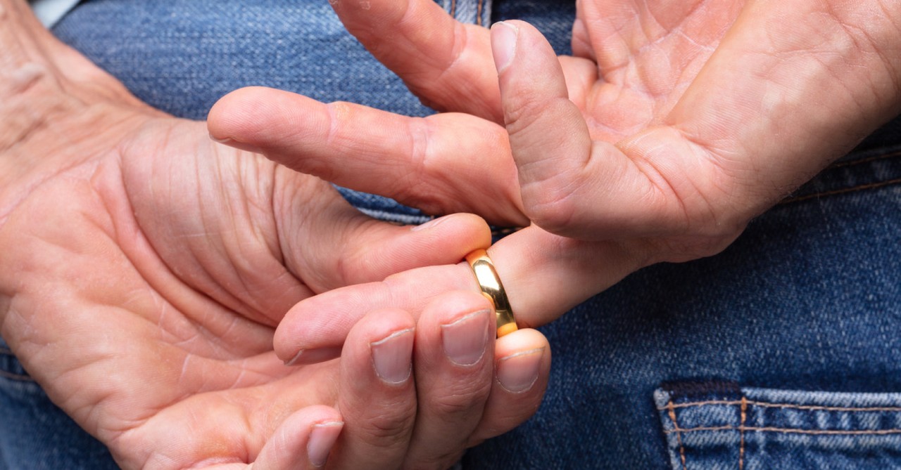 a man playing with his wedding ring, the popularity and peril of infidelity
