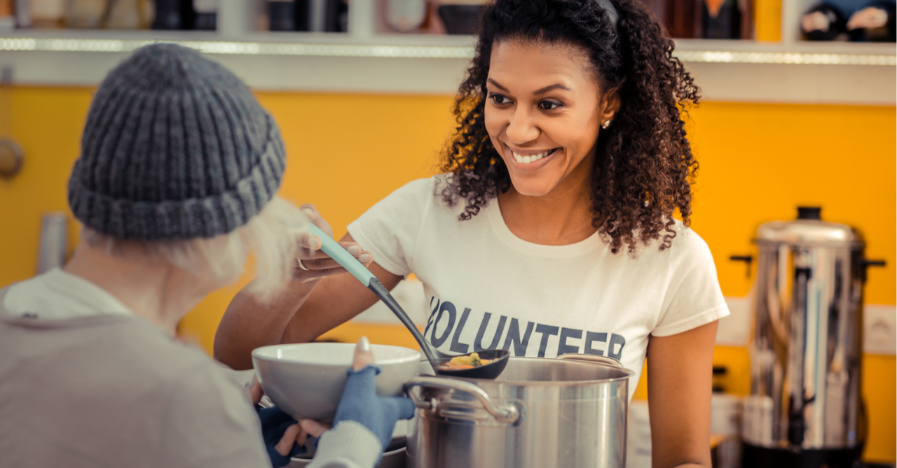 Woman serving soup at a soup kitchen