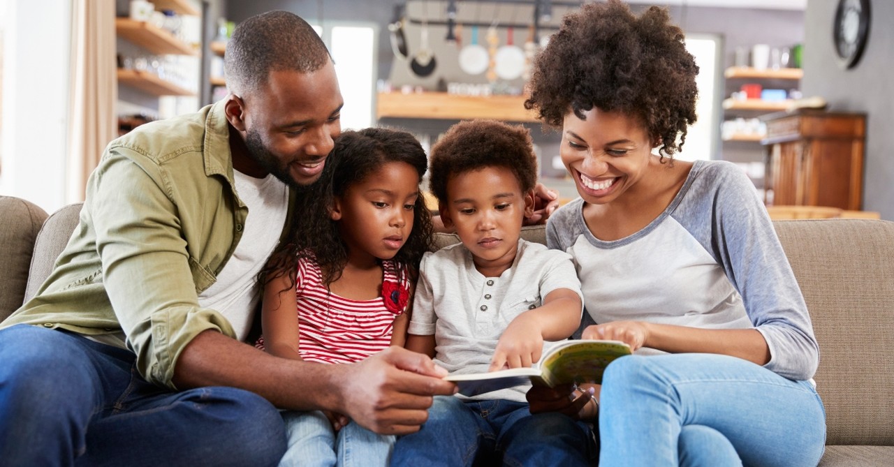 Family reading on the couch together