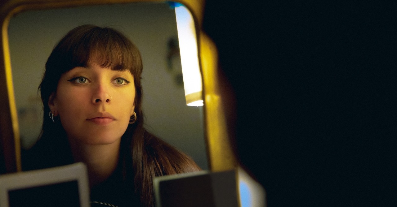 Woman looking at herself in the mirror