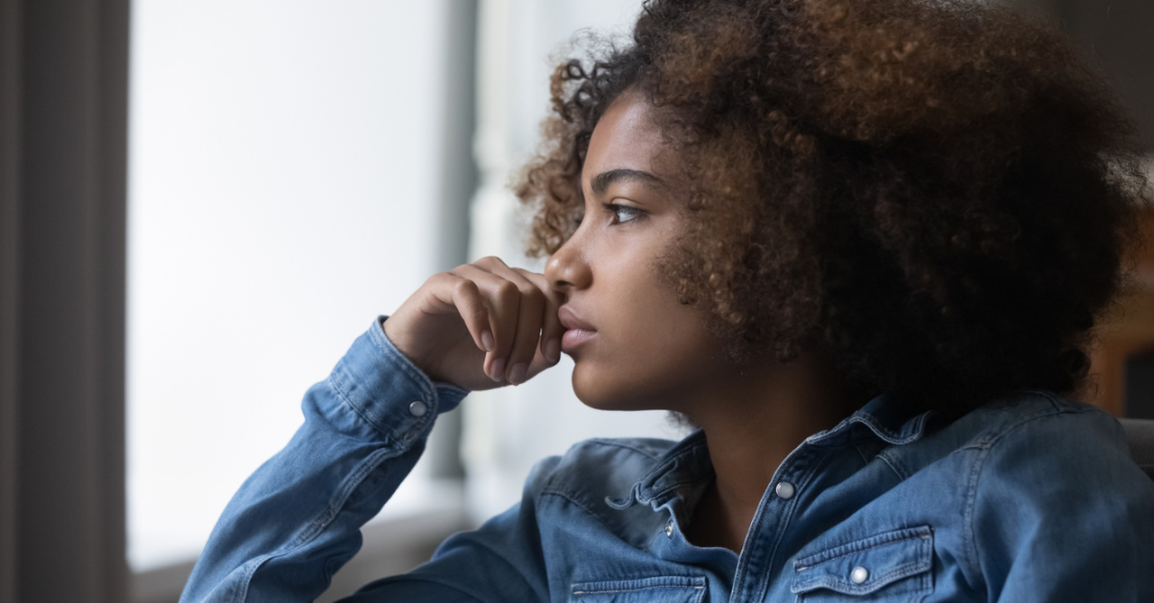 Teen staring out the window; verses I pray when I'm worried my teens aren't connecting to Christ.