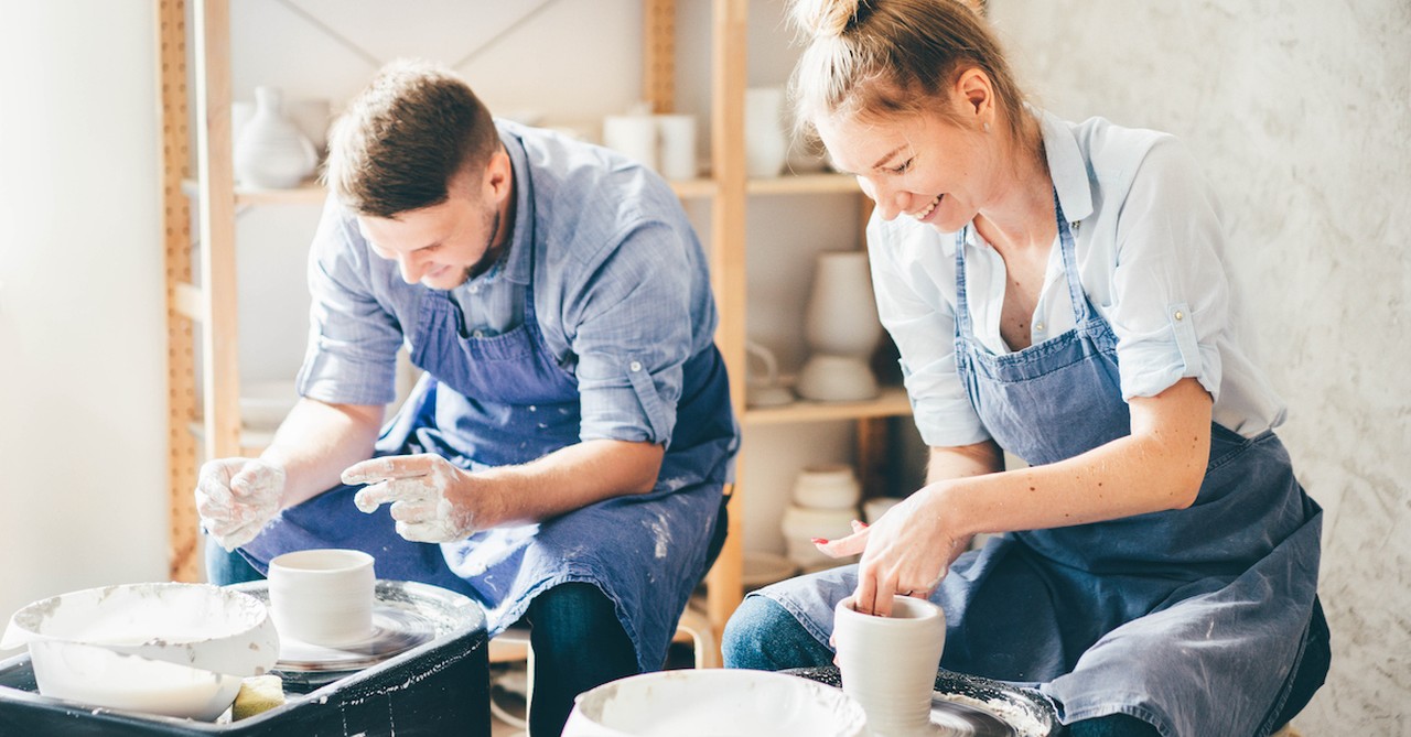 Happy married couple laughing pottery date