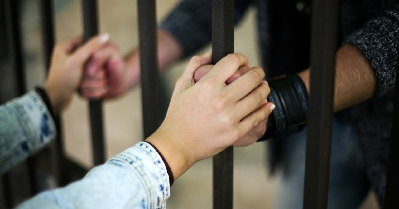 friend holding hands with prisoner illustration for article on onesiphorus