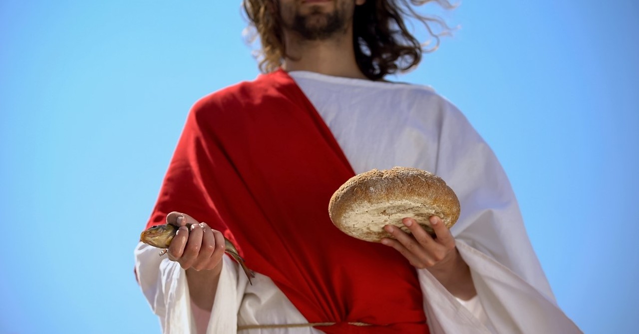 jesus holding bread and fish to illustrate article on was jesus a socialist