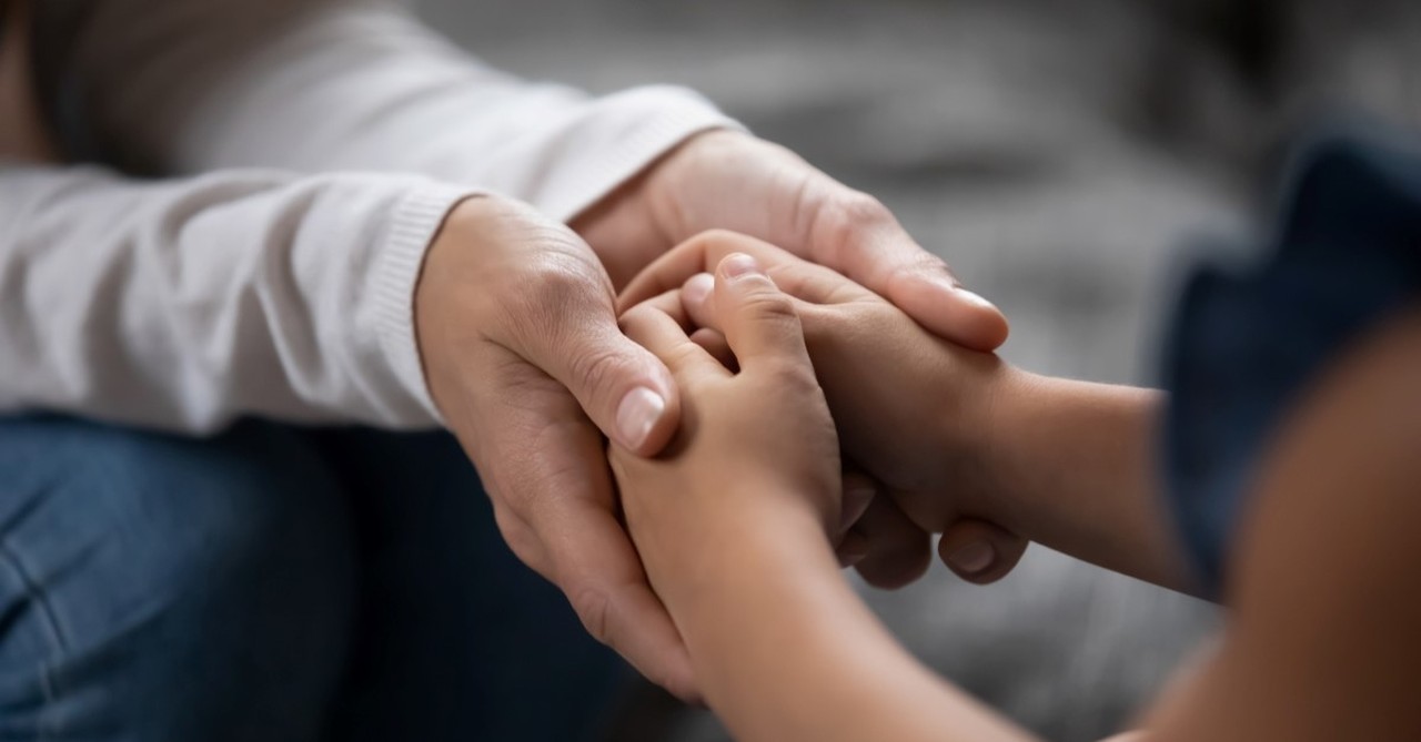 two reconciling people holding hands