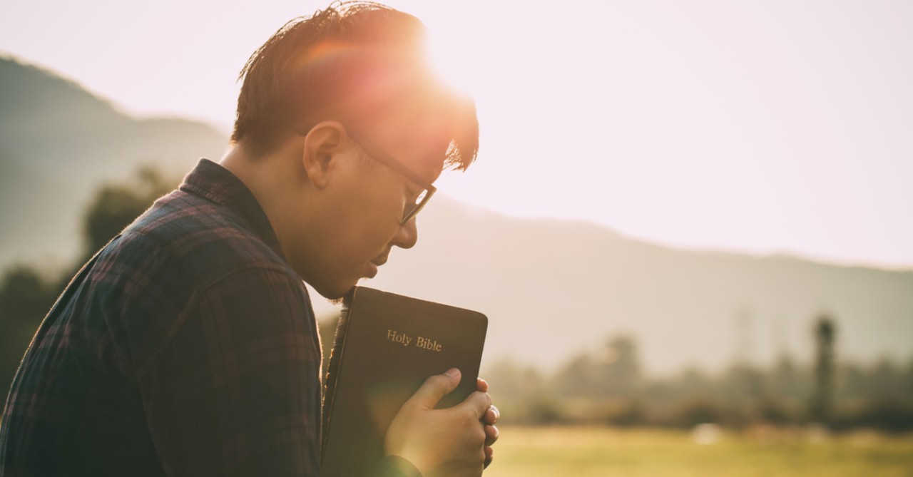 a man with a Bible to his heart, ways that normalization of anxiety can help and ways that it can hurt