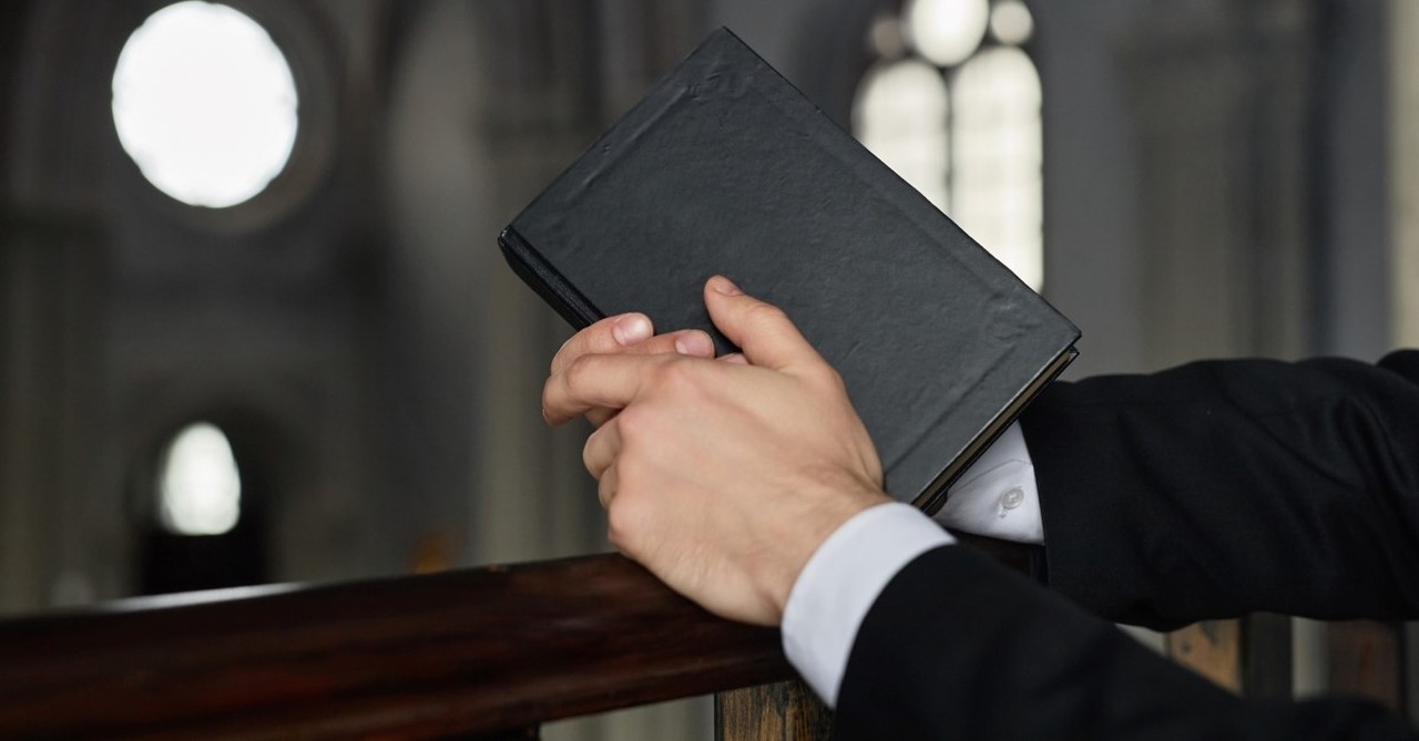 pastor holding bible to illustrate article on a.w. tozer