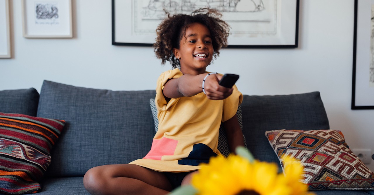 Teen girl watching television show tv remote on couch