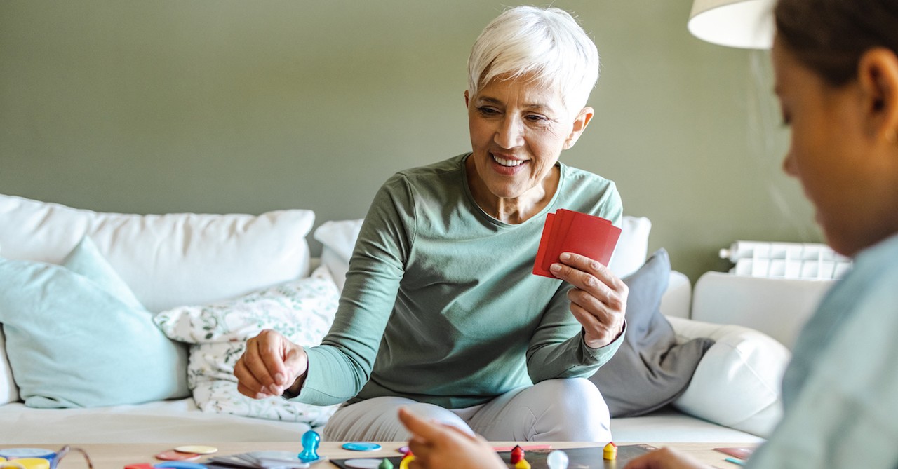 Women playing board game cards together