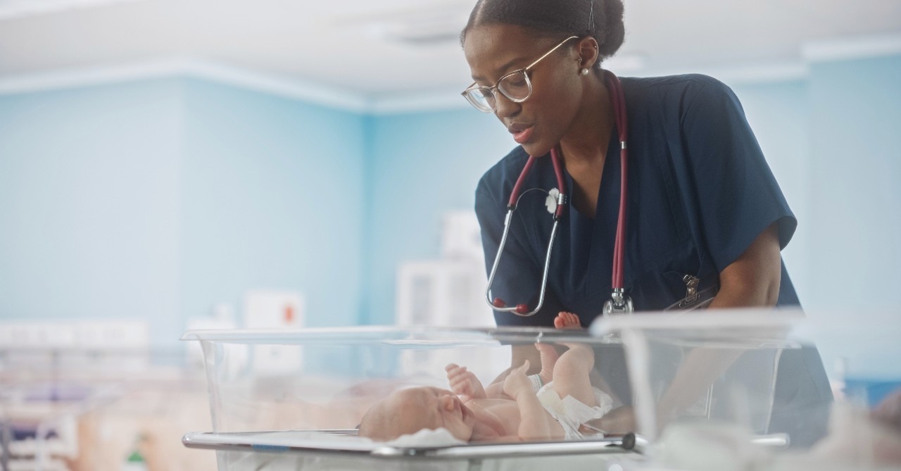 Nurse holding NICU baby