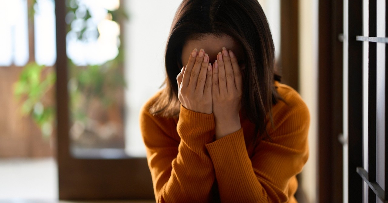 Woman hiding her face