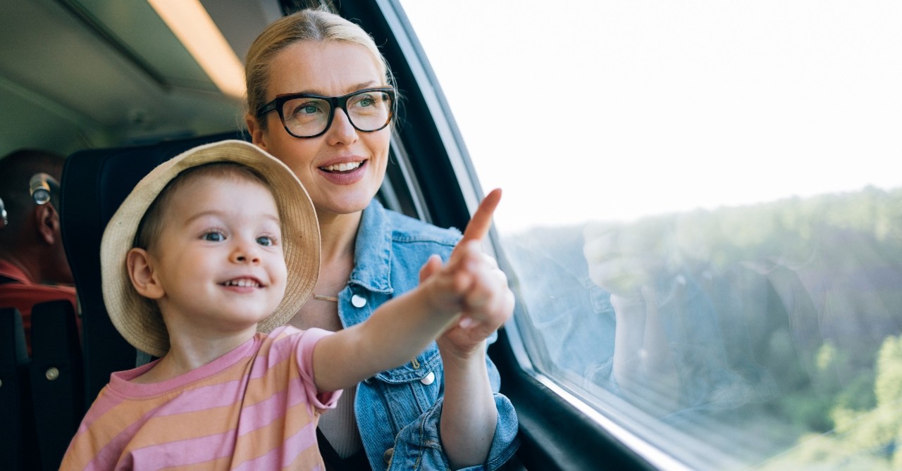 Child pointing out a train window