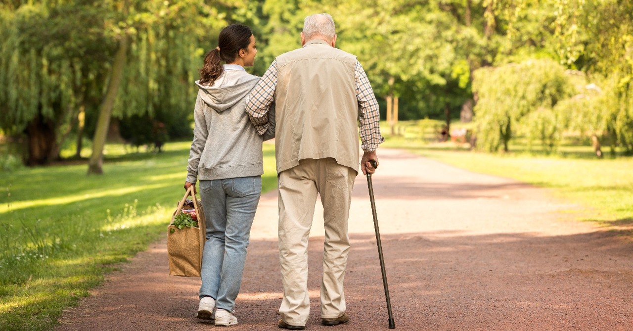 Woman helping elderly man