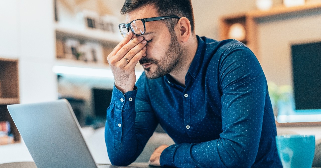 Upset man looking at his computer