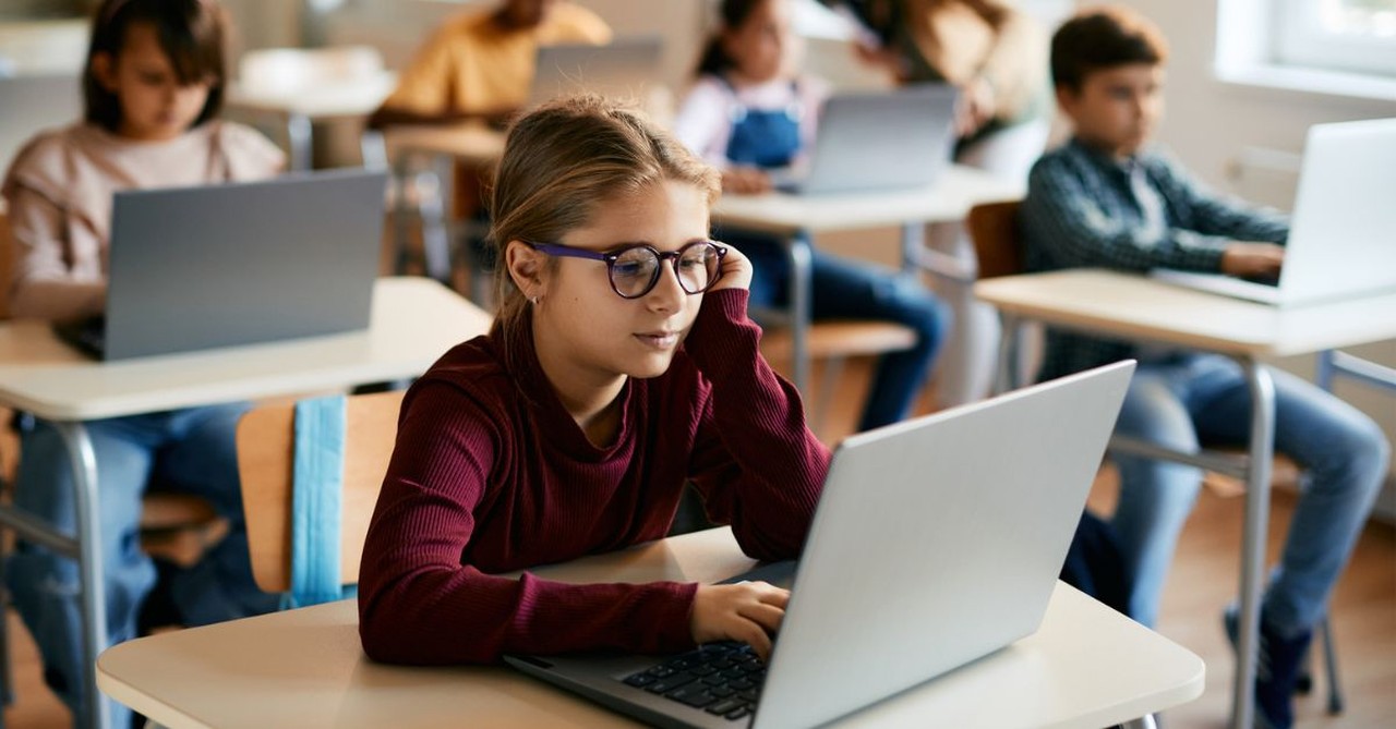 Elementary students testing in school on their computers; State school report cards do not accurately reflect student academic competency.