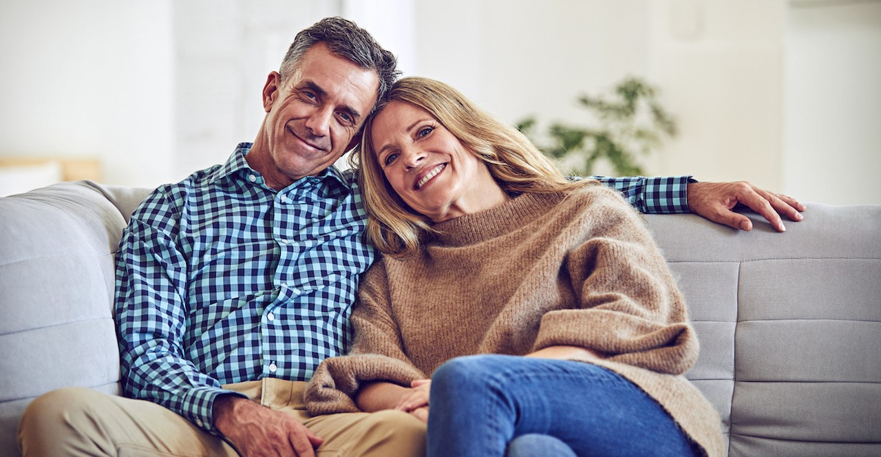 Older married couple happy on couch