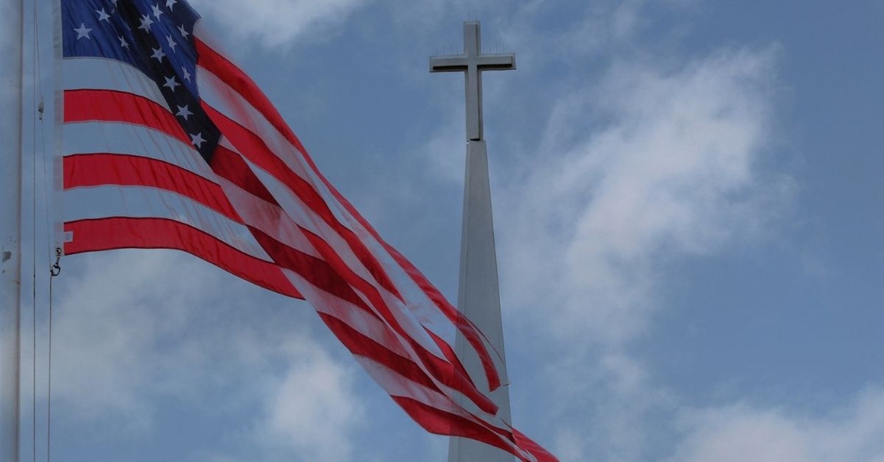 American flag and church steeple; American church groups begin to arrive home from Israel.