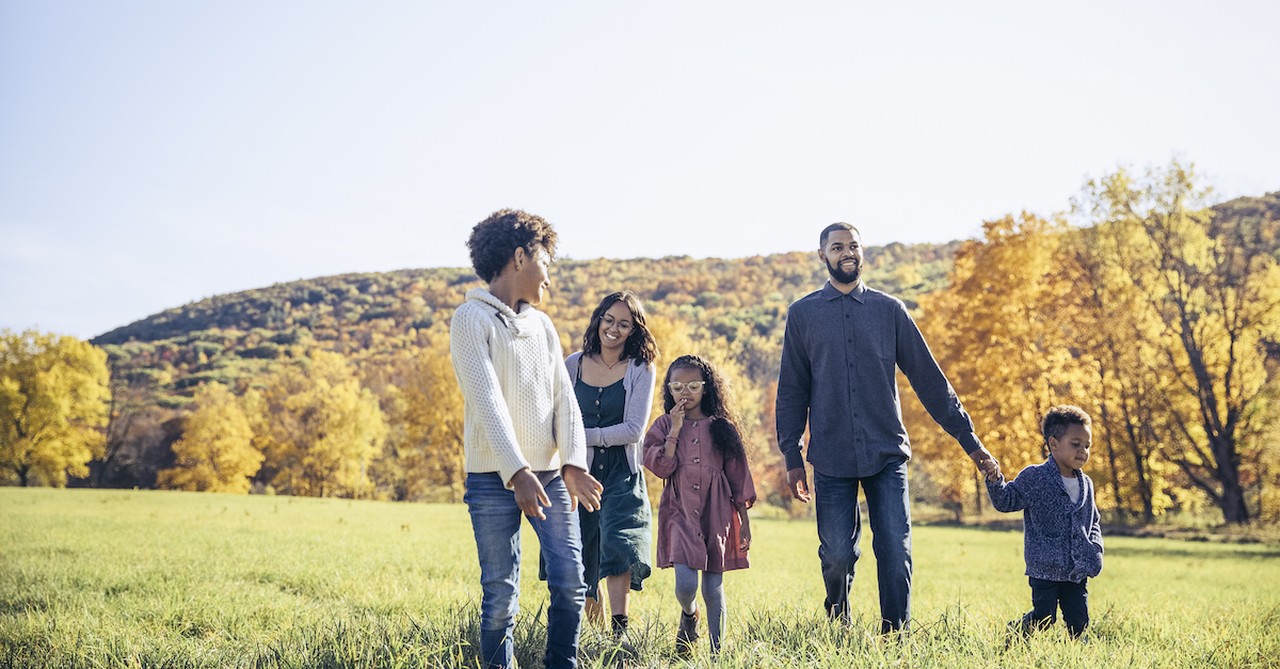 family outside in fall weather having fun walking around