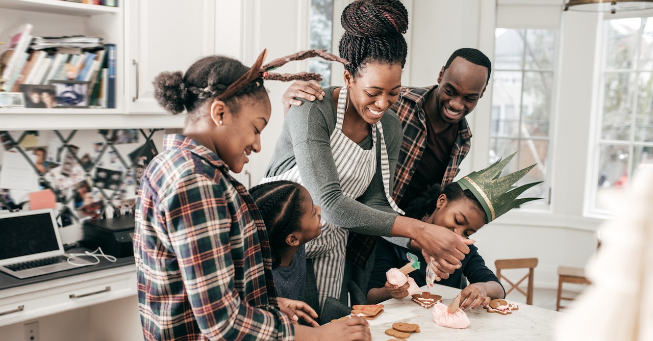 Happy family baking cookies around Christmas in the kitchen