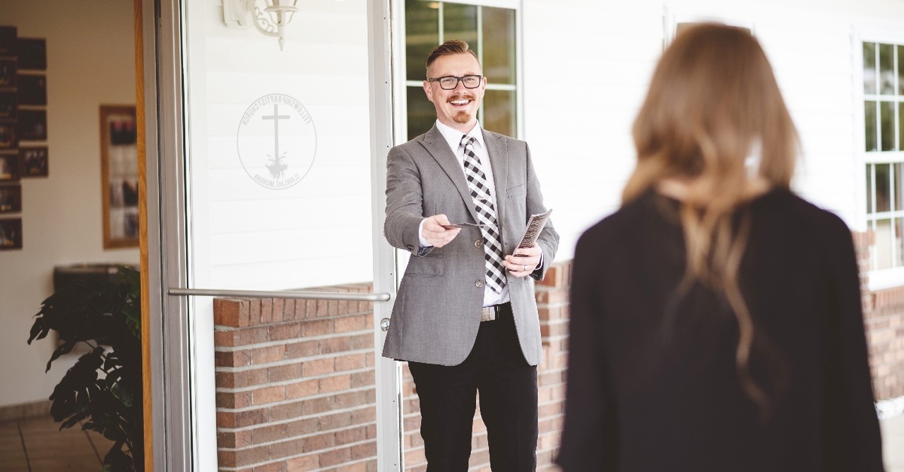 Man welcoming someone to church