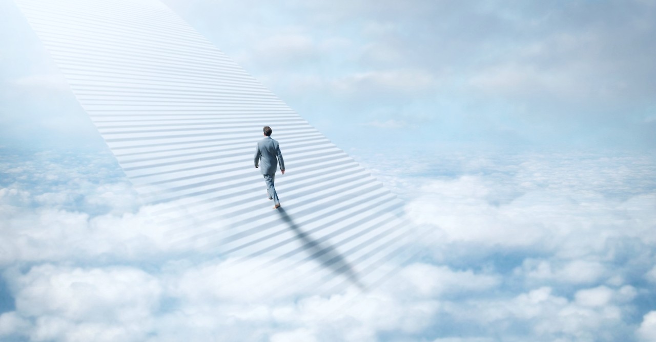 Man walking up a stairway to heaven