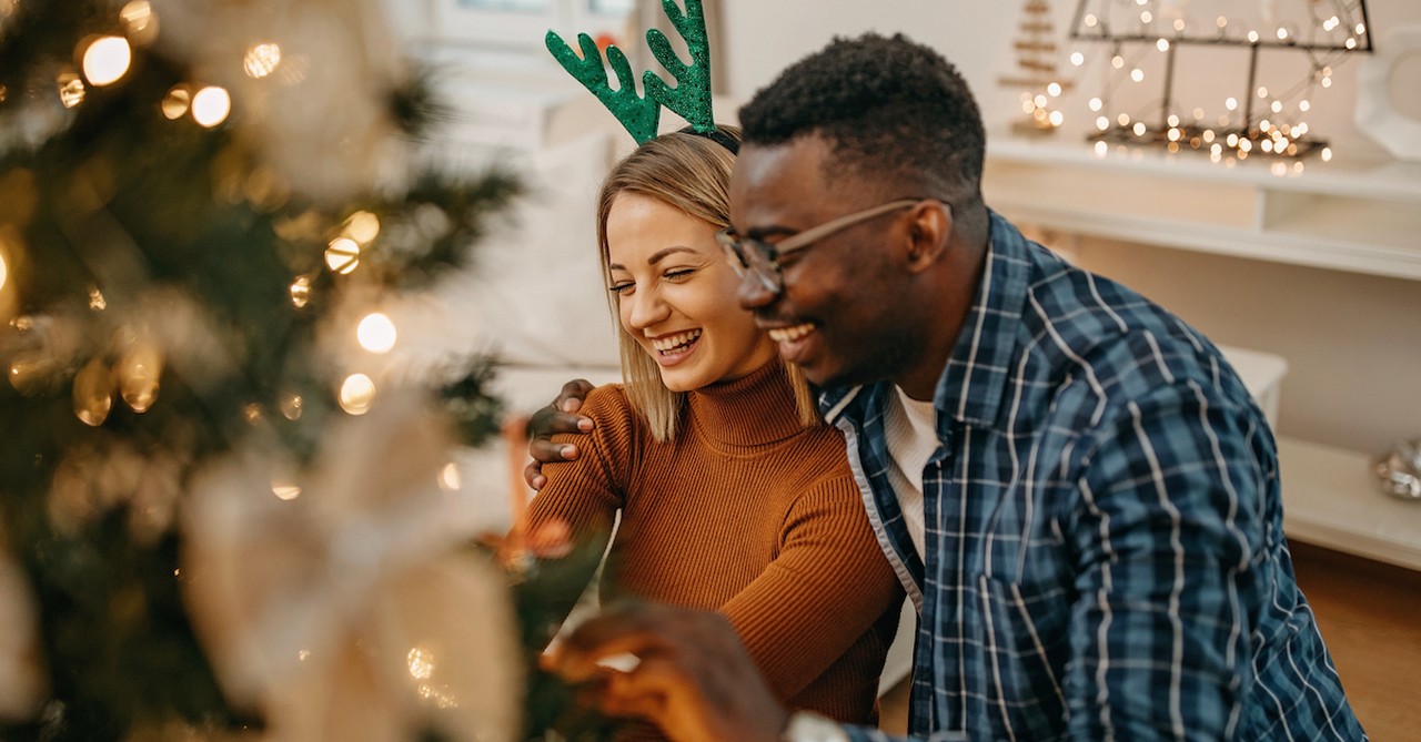 Happy couple decorating Christmas tree