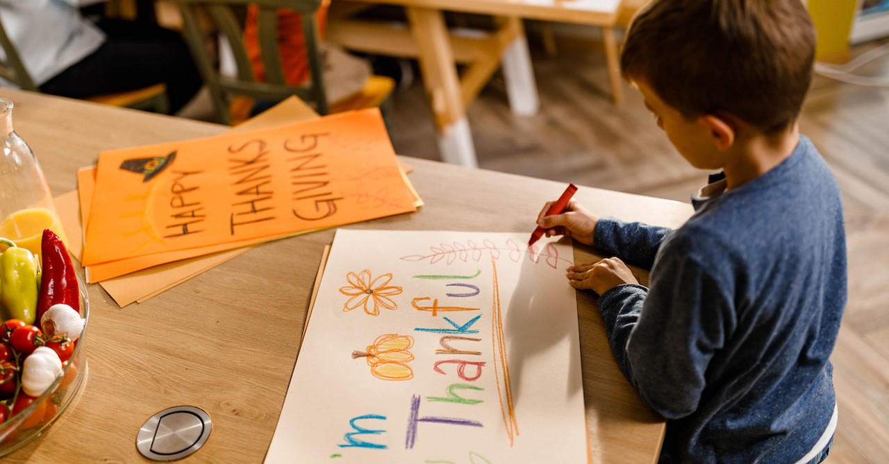 Kid doing Thanksgiving craft coloring gratitude