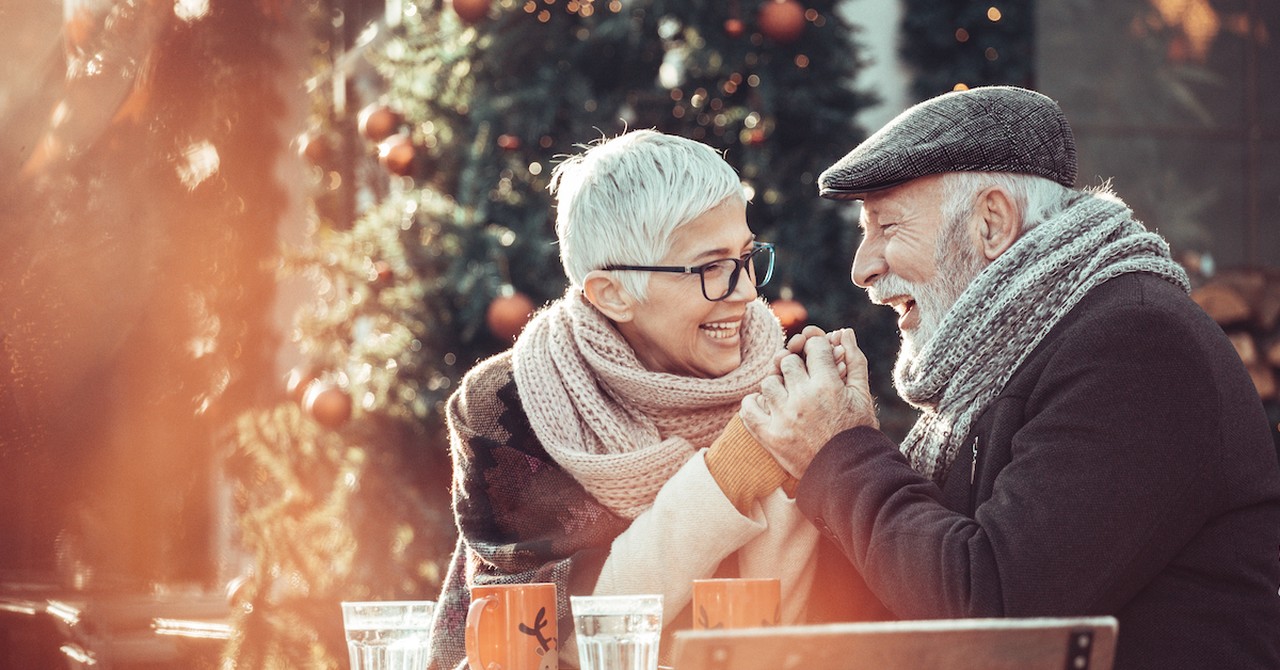 Happy senior couple winter date around Christmas at cafe