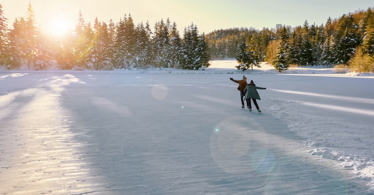 couple on winter date ice skating in snow