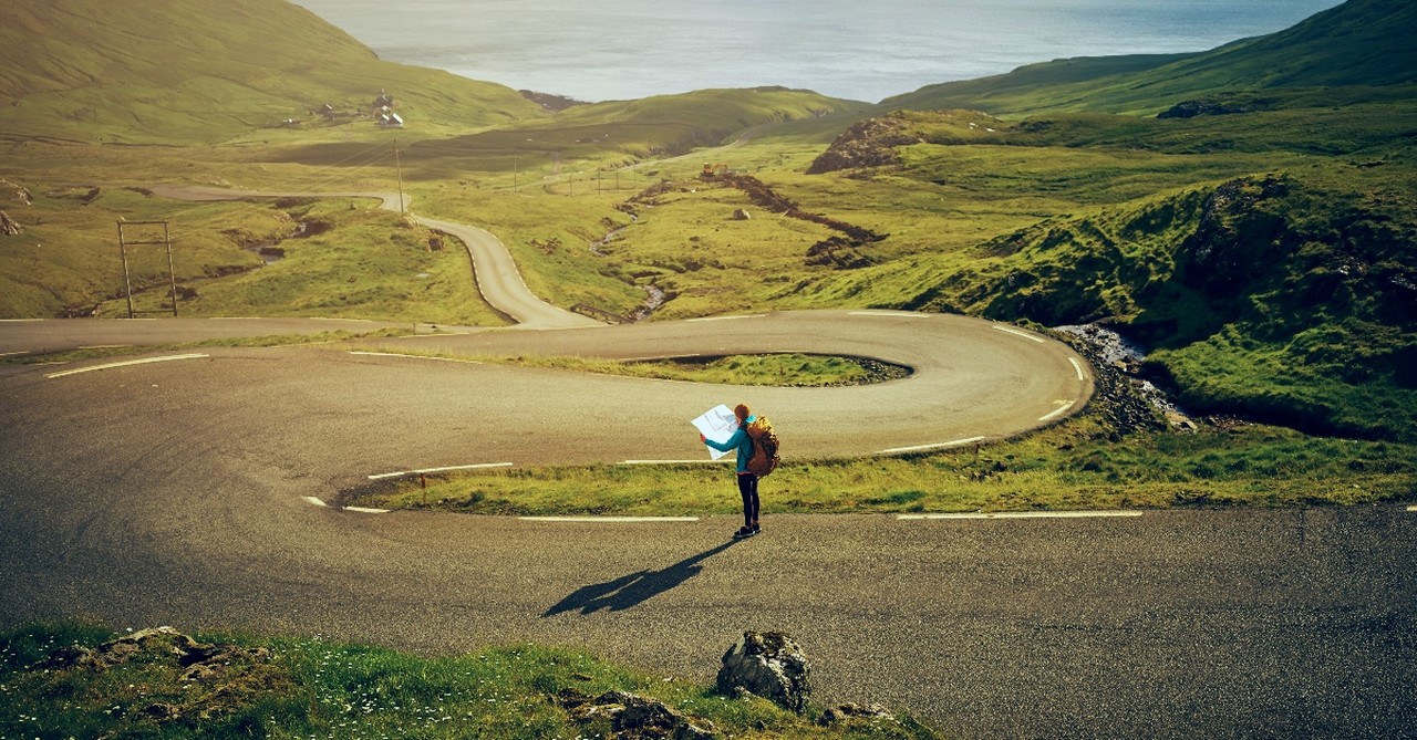 Woman on a road looking at a map