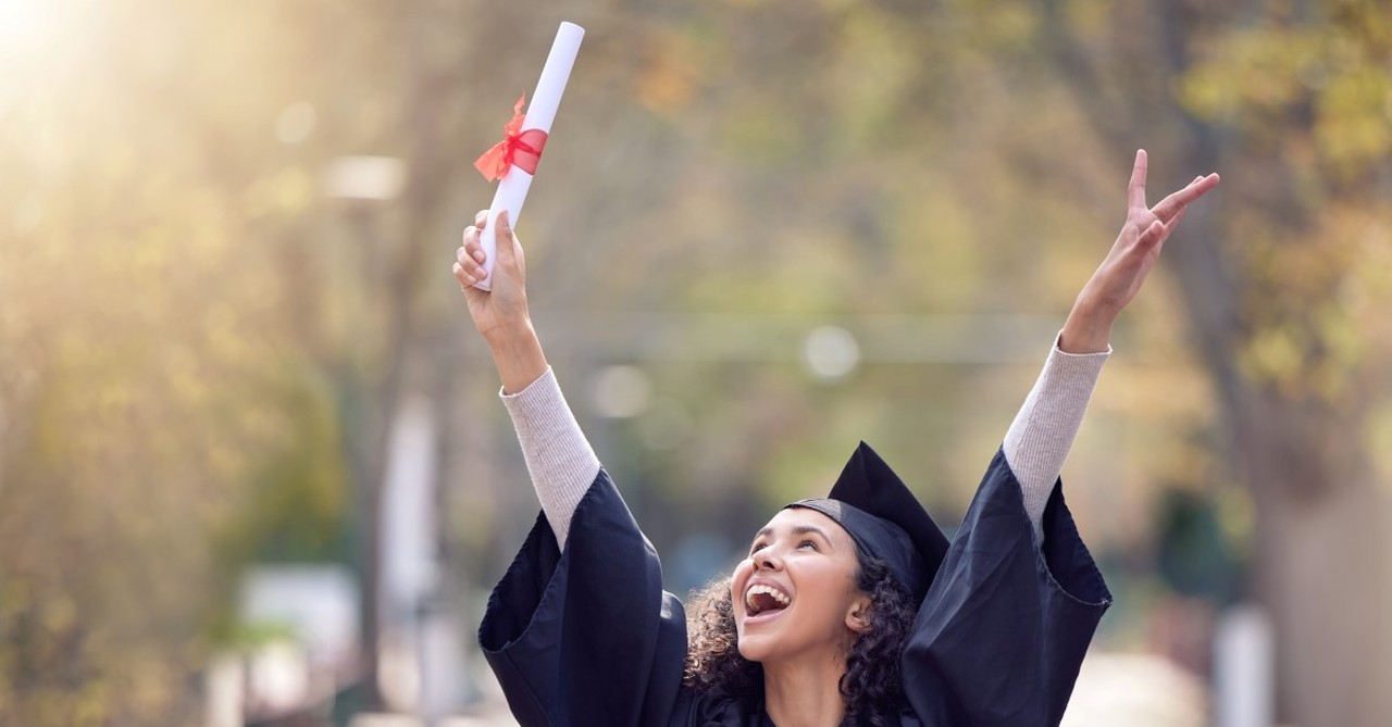 woman cheering on college graduation day