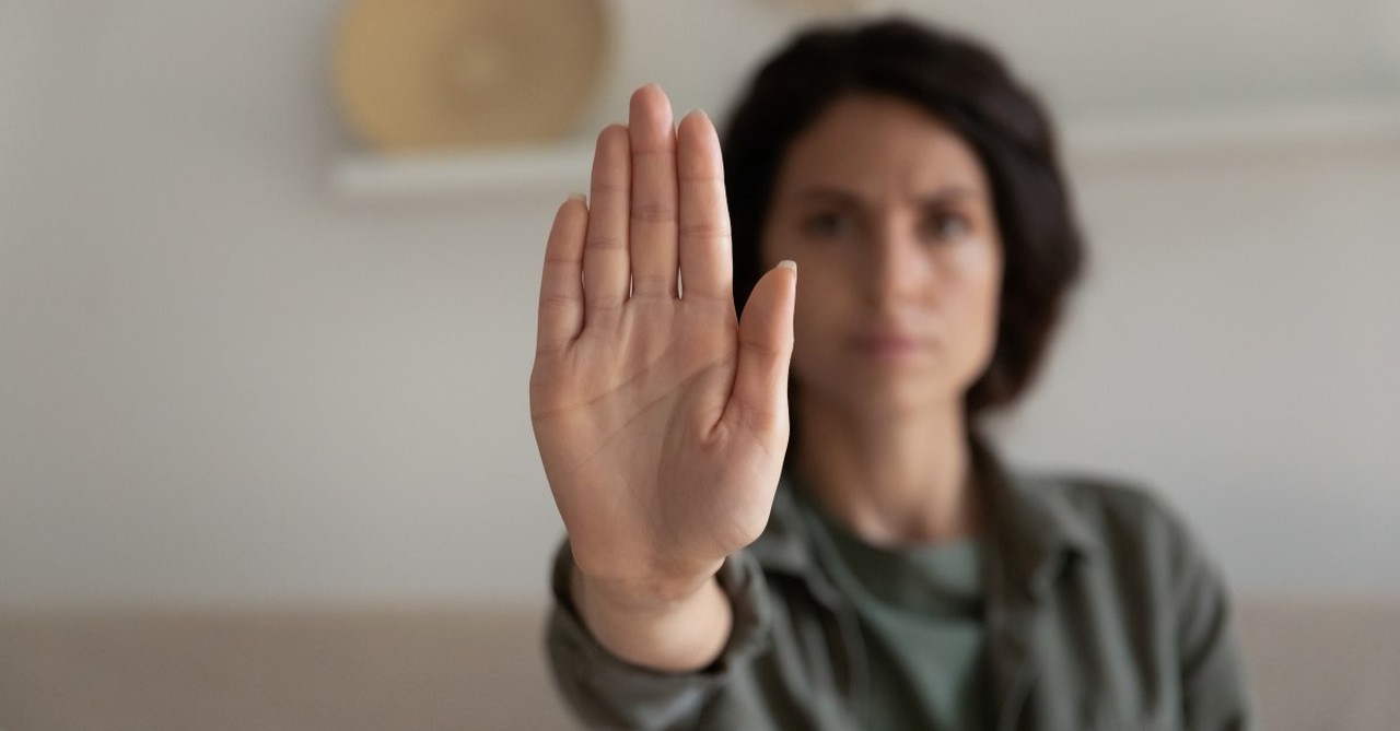 woman holding up hand to say "stop"