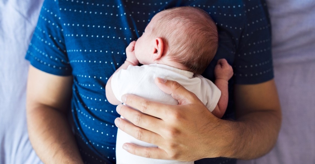 father holding baby