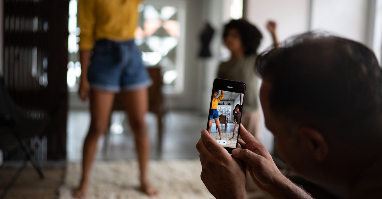 Family videoing kids on phone