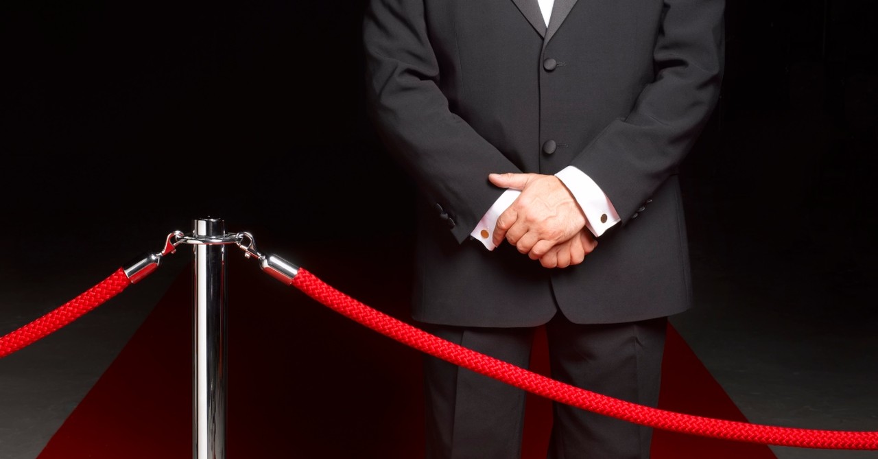 Bouncer, security man blocking an entrance