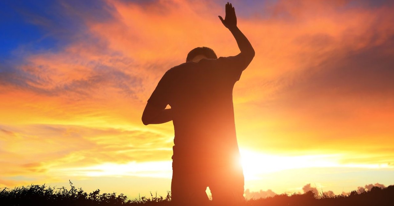 Man in worship outside during sunset, secrets to joy found in christian living