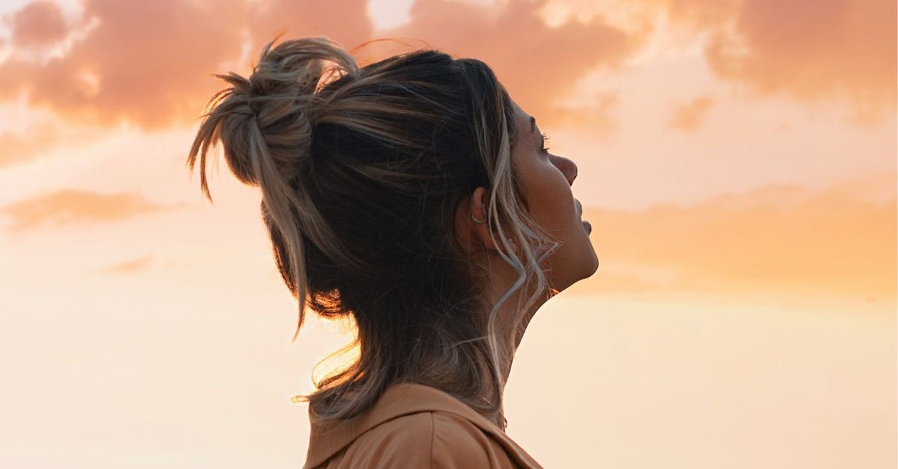 Woman looking up at the sky; who are we?