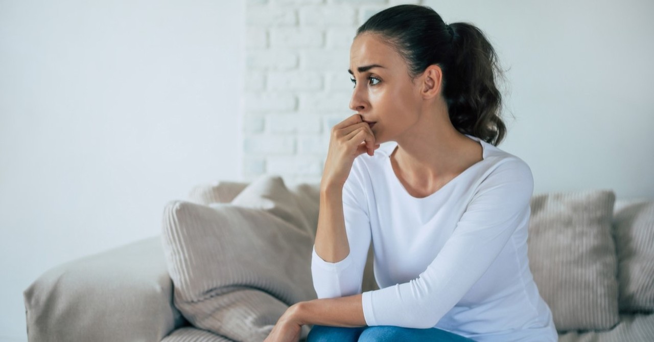 sad woman on couch