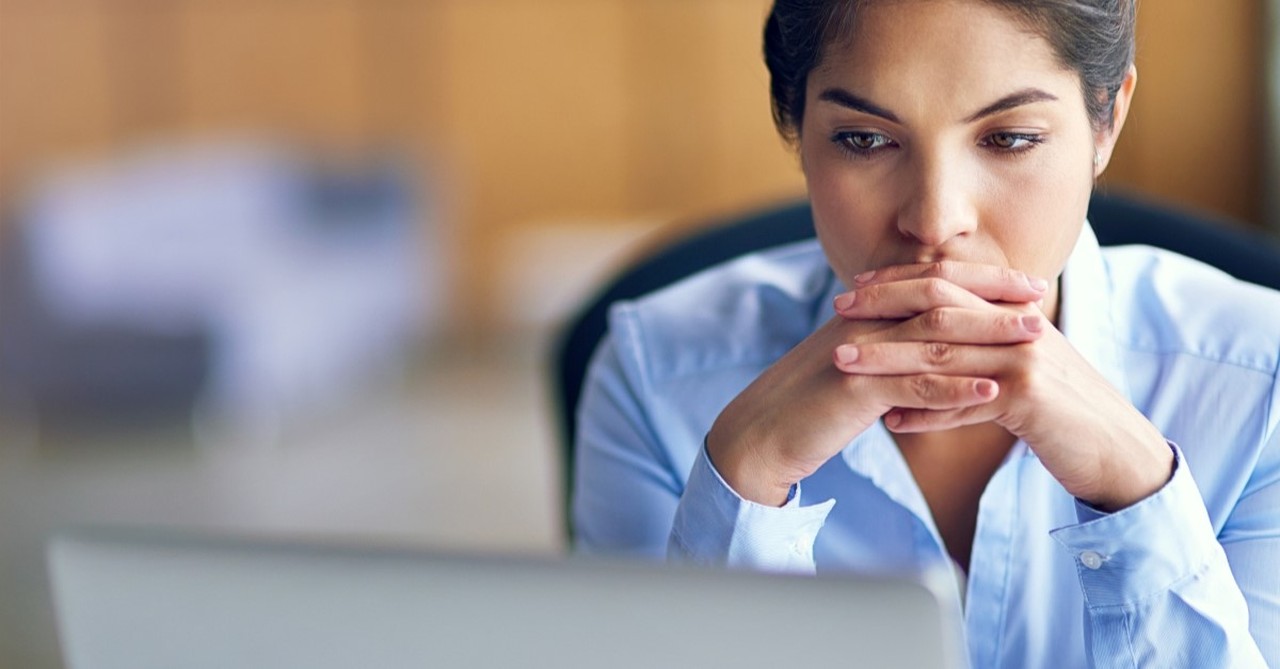 concerned businesswoman looking at laptop