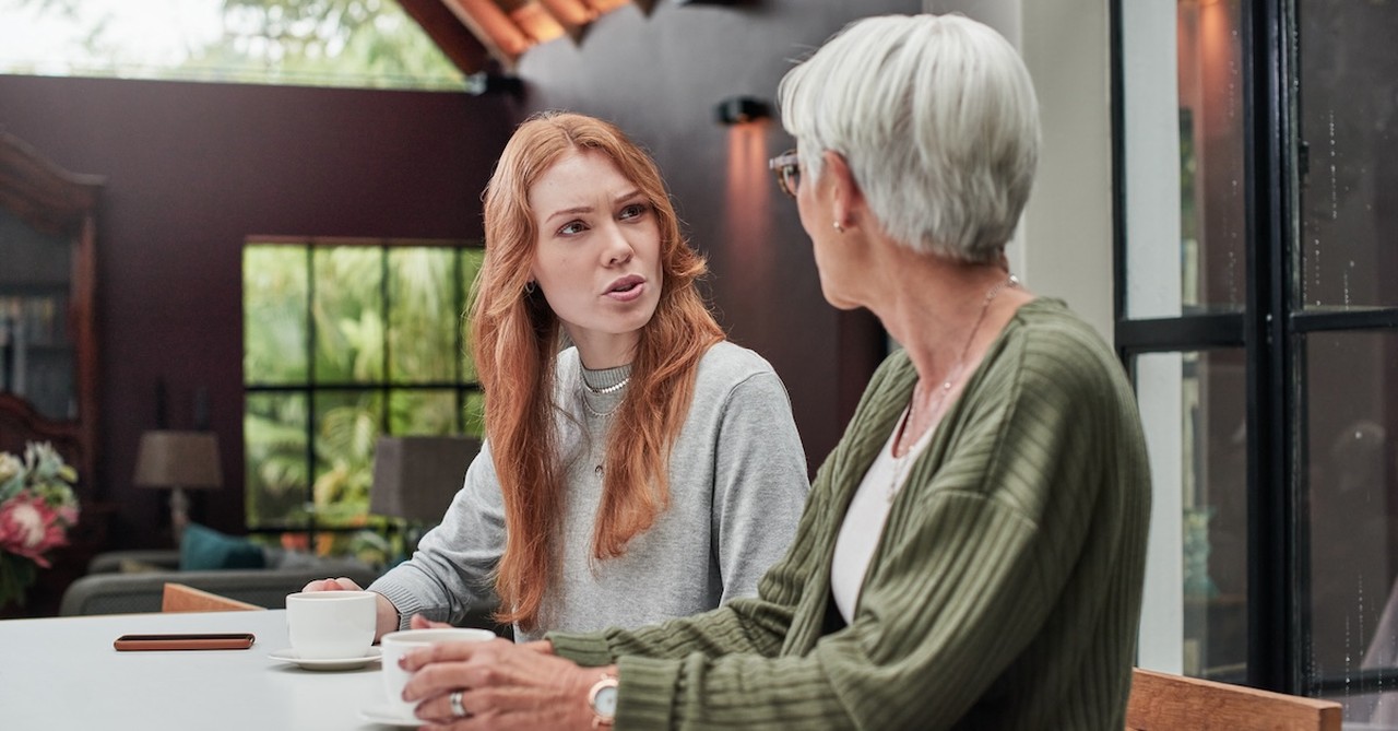 Toxic mom serious talking with adult daughter setting boundaries in kitchen