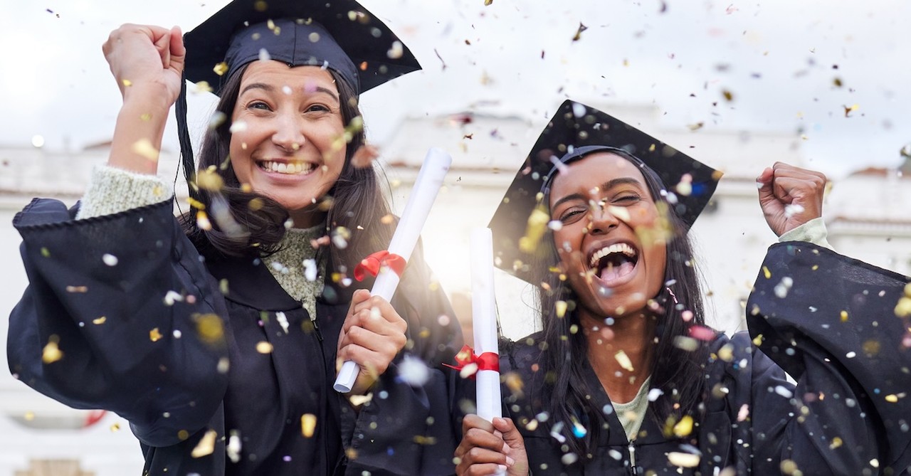 Happy graduates friends celebrating at graduation